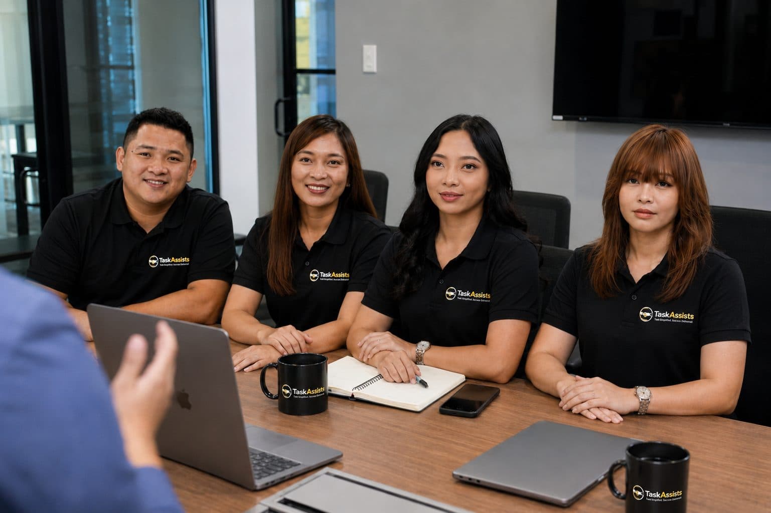 The TaskAssists team meeting with a client